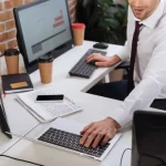 depositphotos_431422814-stock-photo-cropped-view-businessman-using-laptop